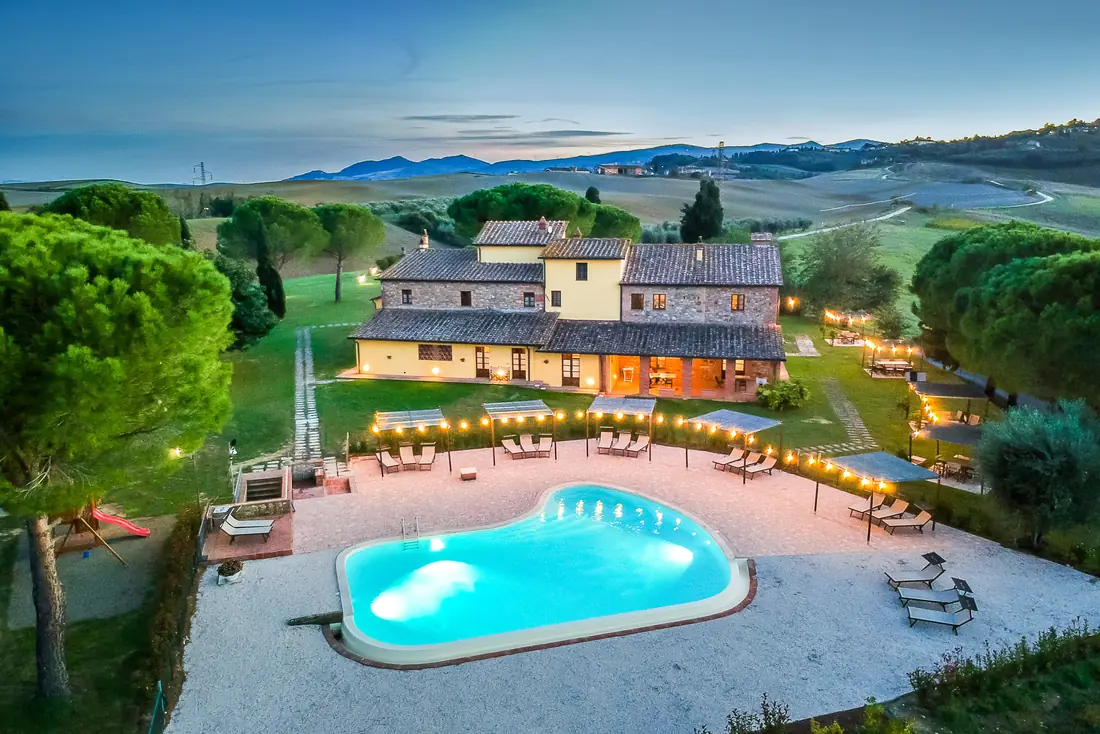 Casa d’Era at sunset, with the pool and the Tuscan hills